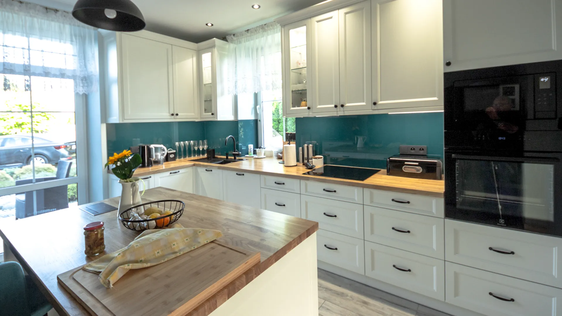 White Shaker kitchen in Warsaw with glass-front cabinets and solid wood countertops