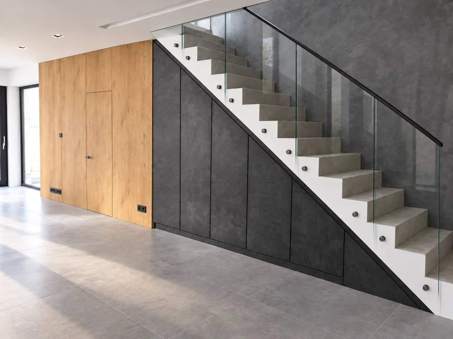 Under-stair storage and oak wall paneling with a concealed door in Katowice